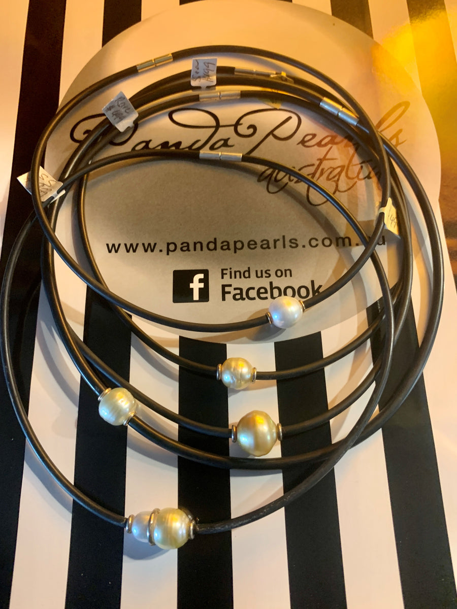 Australian South Sea pearl set in 18 carat on black neoprene.